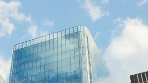 Low-angle architectural view of the top sections of a modern glass office skyscr Stock Footage 338027341