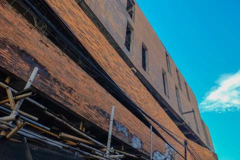 Low angle architecture of brick style building with clear blue sky. Backgroun Stock Photos