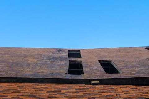 Low angle architecture of brick style building with clear blue sky. Backgroun Stock Photos