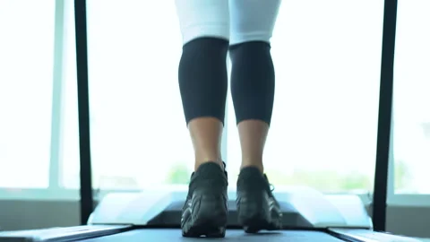 Low angle back view of leg and shoes of Attractive young sports woman running Stock Footage 146319119