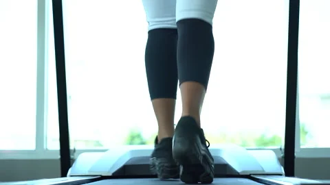 Low angle back view of leg and shoes of Attractive young sports woman running Stock Footage 147424072