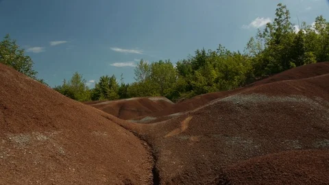 Low Angle of Badlands with Treeline emerging at Top Stock Footage 92624365