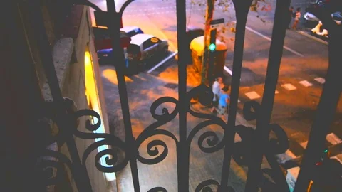Low angle in a balcony in night time street in Barcelona, with bus passing Stock Footage 83038940