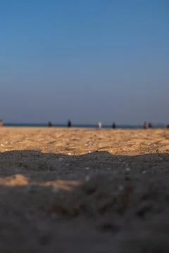 Low angle beach scene with rippled sand and blurred horizon line Stock Photos