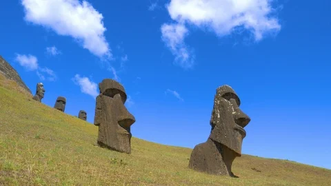 LOW ANGLE: Beautiful blue sky spans above a group of ancient moai sculptures. Stock Footage 111233270