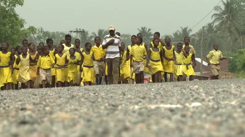 LOW ANGLE - A BIG GROUP OF STUDENTS WALK UP THE ROAD Stock Footage 60633319
