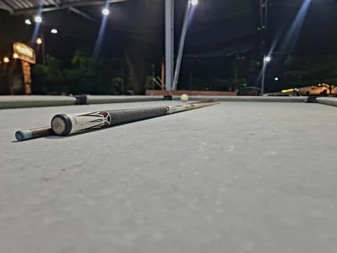 Low Angle Billiards Shot with Cue Stick and White Ball on Table Stock Photos