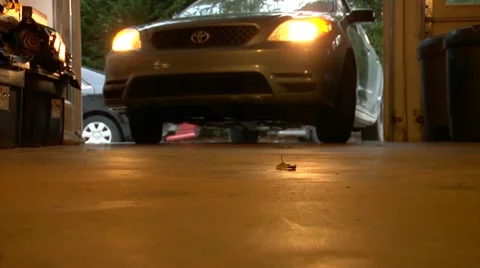 Low Angle of Blue Car Pulling into a Garage 스톡 동영상 12359384