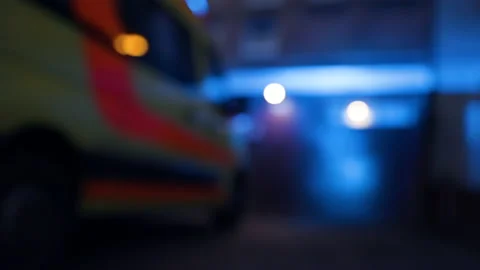 Low angle: Blue flashing emergency lights of ambulance at night Stock Footage 140539992