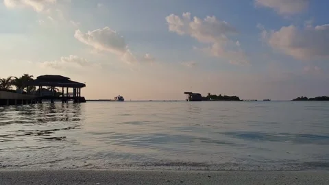 Low angle of boat approaching Maldives pier at sunset Видео 279840642