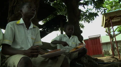 LOW ANGLE: BOY STUDENTS EAT LUNCH AT ADEISO SCHOOL Stock Footage 58070279