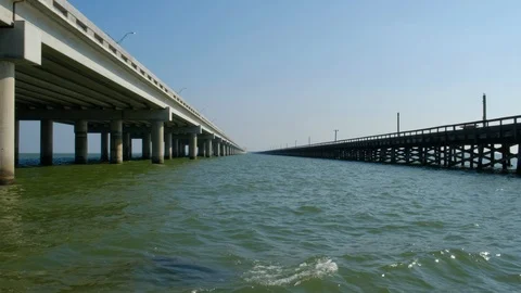 Low angle of bridge and pier over water Video stock 109501756