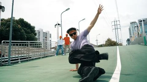 Low angle camera of dancer doing freeze pose while looking at camera. Sprightly. Stock Photos