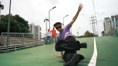 Low angle camera of dancer doing freeze pose while looking at camera. Sprightly. Stockfoto's