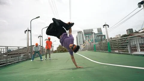 Low angle camera of dancer doing freeze pose while looking at camera. Sprightly. 写真素材