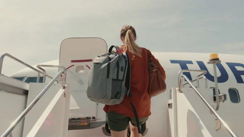 Low angle camera follows young tourist woman with backpack boarding airplane Stock Footage 172007853