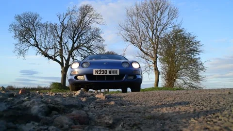 Low angle car driving over camera on country road at sunset york united kingdom Stock Footage 143403234