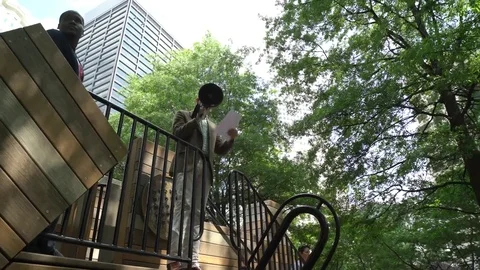 Low angle of Caucasian man on a stage reading page using megaphone Stock Footage 76835855
