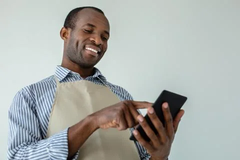 Low angle of cheerful afro maericna waiter Stock Photos