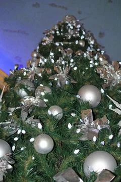A low angle of a Christmas Tree with silver and white ornaments Stock Photos