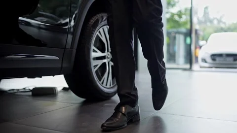 A low-angle cinematic shot of a wealthy man walking with style and confiden.. 스톡 동영상 314204654
