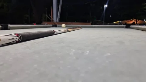 Low Angle Cinematic Tracking Shot of a Pool Cue with Blue Tip Moving Towards 스톡 동영상 333466419