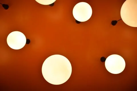 Low angle circle lamp with orange background Stock Photos