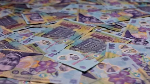 Low angle circular slide over romanian currency layer Stock Footage 72415982
