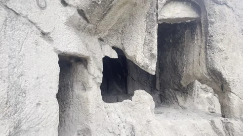 Low Angle Close Up of Ancient Rock Cut Caves and Chambers at Vardzia Cave Видео 337217593