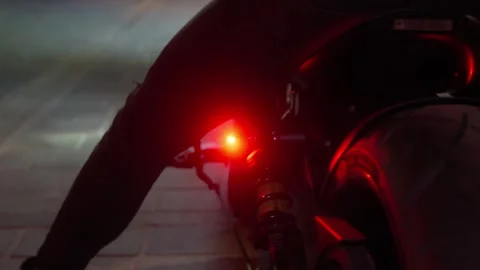 Low angle close up. Back wheel of a motorcycle before driving away at night Video stock 236090332