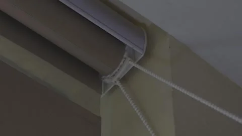 Low Angle Close Up of a Beaded Pull Chain on a Roller Blind Mechanism Stock Footage 345131905