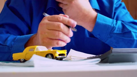 Low angle close up of businessman signing vehicle registration document Stock Footage 337674466