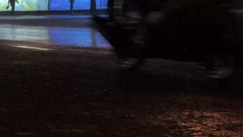 Low angle Close up of Car and motorbike Wheels driving on wet city road at 스톡 동영상 343041874
