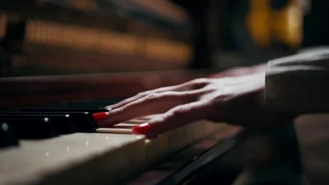 Low-angle close-up of female hands playing piano keys Video stock 325729274