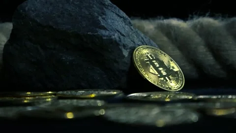 Low angle close up footage of bitcoin cryptocurrency coins on a dark studio Stock Footage 302283790