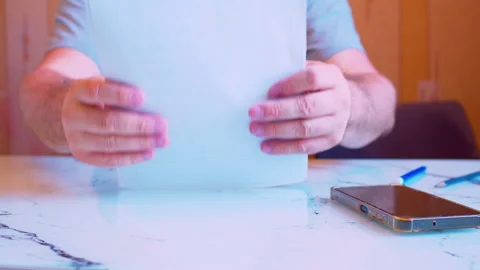 Low angle close-up of hands trying to stack paper documents. Stock Footage 336696106