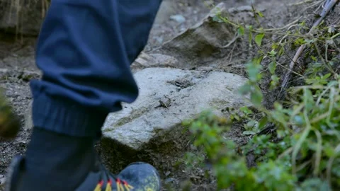 Low angle close up of hiker shoe stepping on rock along mountain path Stock Footage 338090133