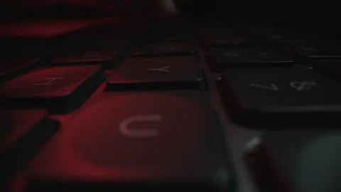 Low Angle Close-Up of Keyboard in Dramatic Red Lighting Stock Footage 337996261