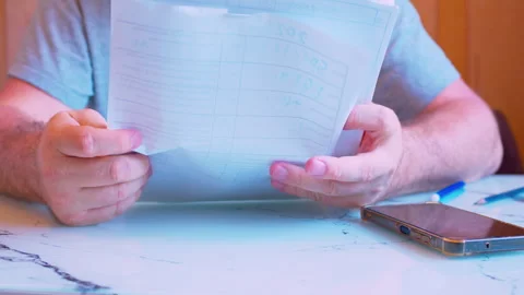 Low angle close-up of a man sorting paper documents. Stock Footage 336696211