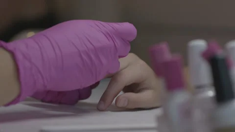 Low angle close-up of manicure performed on young woman's hand Stock Footage 231355544