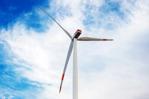 Low angle close-up of a modern wind turbine generator under a blue sky Stock Photos