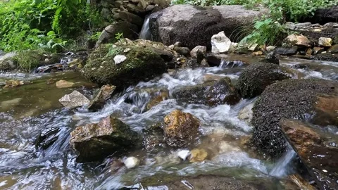Low-angle close-up of mountain stream beneath Wonderful Bridges Stock Footage 333295637