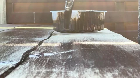 Low Angle Close-Up of Paint Brush Applying Dark Stain to Wooden Board Stock Footage 346877249