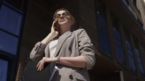 Low Angle Close-Up of Realtor on Phone in Modern Complex Stock Footage 311853643