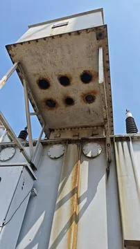 Low angle close up of rusty metal cable terminal box and cooling housing. Stock Photos