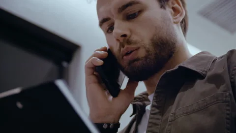 Low Angle Close-Up of Serious Bearded Businessman Talking on the Phone and Video stock 321017605