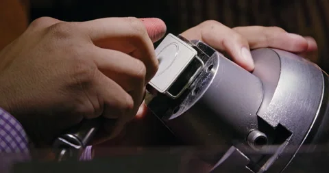 Low angle close up shot of a craftsman jeweler working on a belt buckle. Stock Footage 137268372