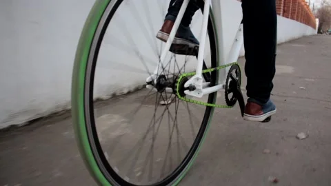 Low angle close up shot of green sport bike tyres moving on cement pavement Stock Footage 132673994
