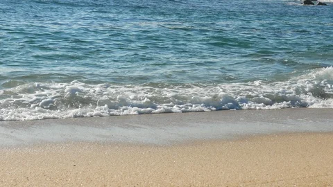 Low angle close up shot of ocean waves breaking on the sandy beach in summer Stock Footage 108518440