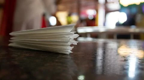 Low angle close up shot of white tissue papers on table. Stock Photos